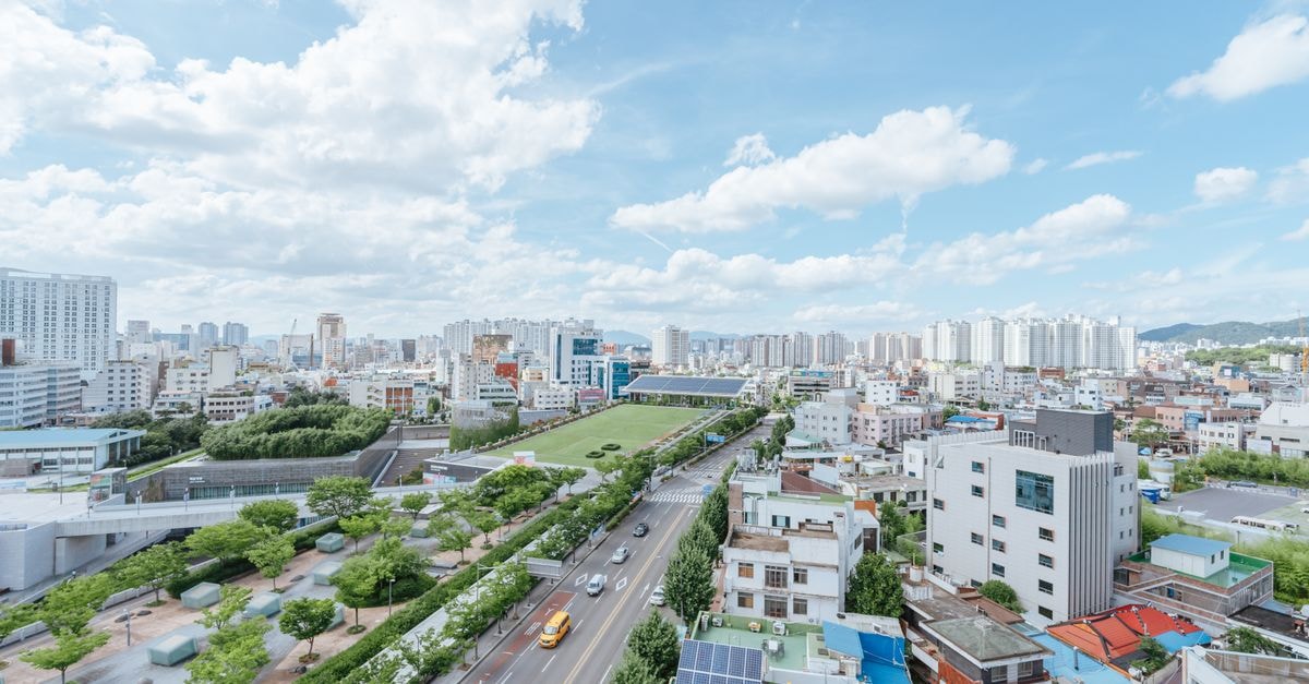 Aerial view of a bustling cityscape with modern architecture and blue sky.