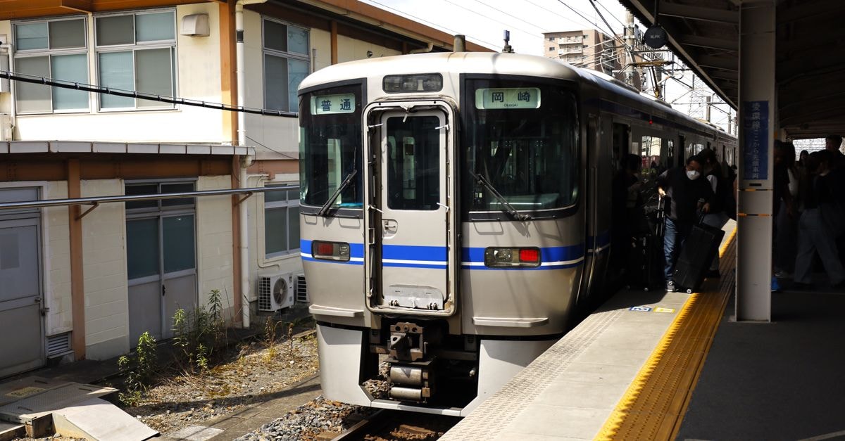 Iksan travel guide: a quiet railway hub worth slowing down for A local train at Kasugai Station, Aichi, Japan, with passengers boarding on a sunny day.