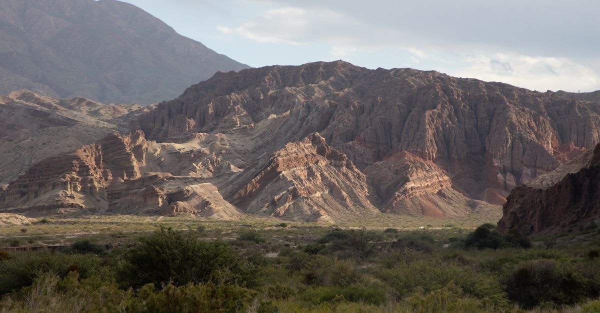 Inter Apart Hotel in Salta: Modern Stays Near Plaza 9 de Julio Breathtaking view of rugged mountains and desert flora in Salta, Argentina.