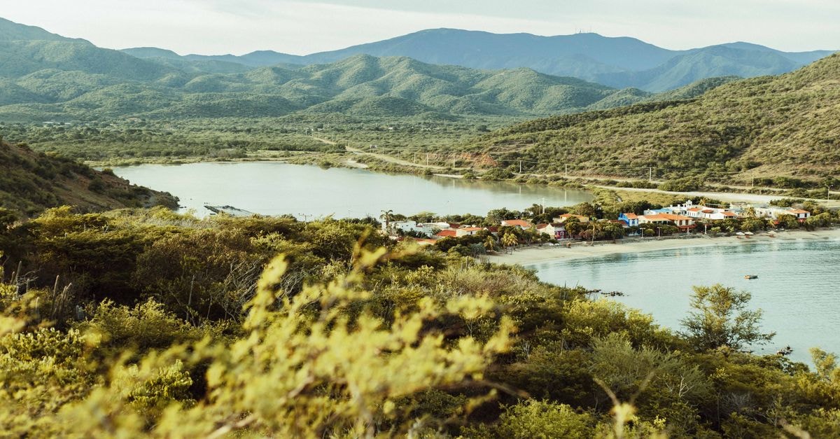 A Quiet Inland Discovery: Bonao Travel Guide Breathtaking coastal landscape with village and mountains in Nueva Esparta, Venezuela.