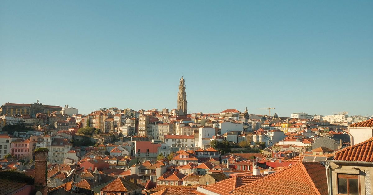 Ji Hotel Heze Renmin Road: A Practical Base on a Central Heze Street Panoramic view of Porto's historic district showcasing red rooftops and the iconic Clerigos Tower under a clear blue sky.