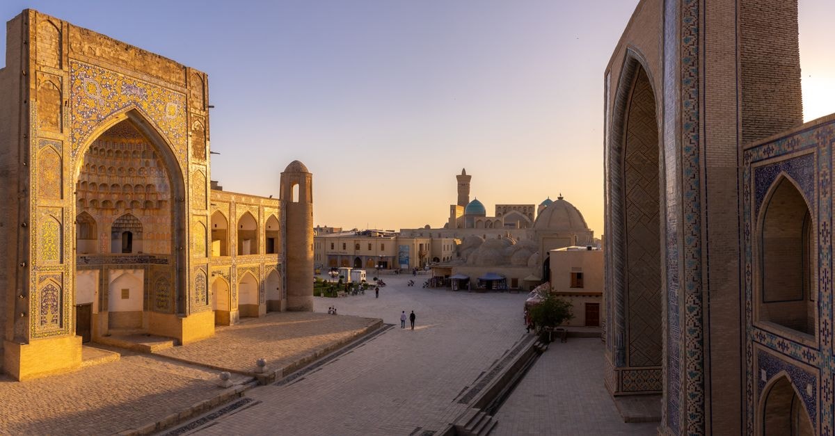 Stunning sunset view of ancient architecture in Bukhara, Uzbekistan, showcasing historical charm.