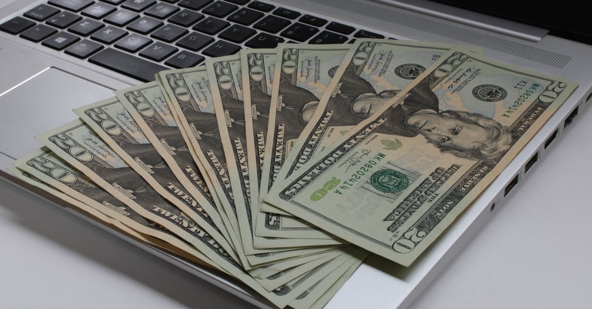 Brookfield signs US$2.8 billion deal to take Reliance Worldwide private Stack of US dollar bills fanned out on a laptop keyboard, symbolizing online finance.