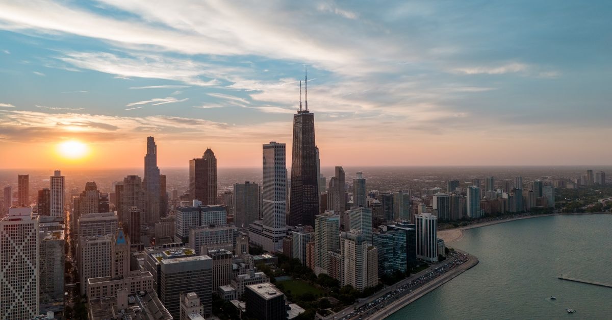 Aerial view of Chicago skyline with Willis Tower at sunset over Lake Michigan.