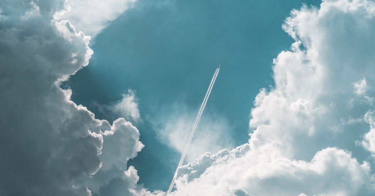 SpaceX Completes 13th Starship Test Flight; SPCX Trades 43% Below Post-IPO Peak An airplane soars high above Ilmenau, Germany, leaving a trail amidst dramatic clouds.