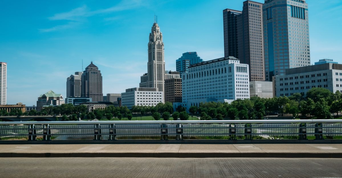 Cleveland Marriott Downtown at Key Tower, Cleveland — Skyline Hotel Steps from the Convention Center View of Columbus skyline featuring high-rise buildings against a blue sky, with urban trees.
