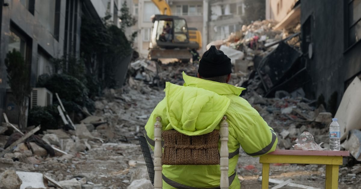 Fi Hostel in Antakya: A Renovated Historic Stay in the Old City A construction worker sitting amidst debris after an earthquake in Antakya, Türkiye.