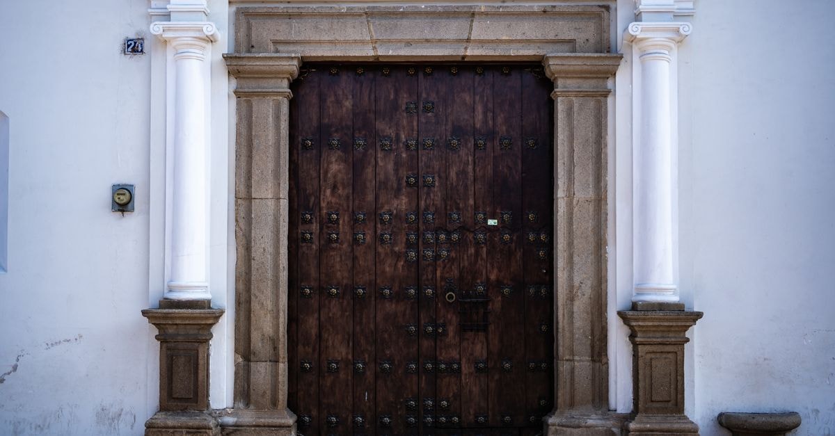 A Quiet Doorway into Guatemala City: Mixco Travel Guide A beautifully detailed wooden door with ornamental columns in Antigua Guatemala.