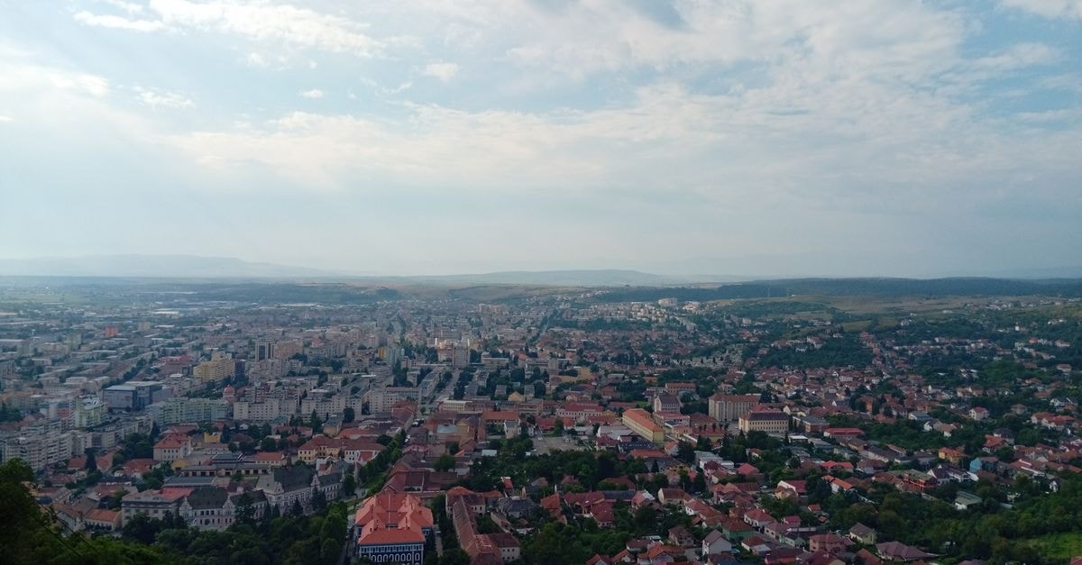Chernivtsi Backpackers, Chernivtsi — A Hostel in the Old Town Core Stunning aerial view of a European cityscape with red-roofed buildings and clear blue skies, capturing the peaceful urban layout.