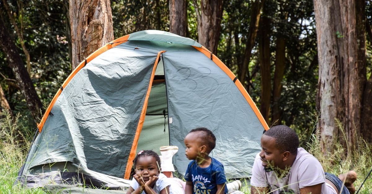 Kakamega Travel Guide: A Quiet Kenyan Town Worth the Detour Father and children enjoying a camping trip in a lush Kenyan forest. Perfect family bonding time.