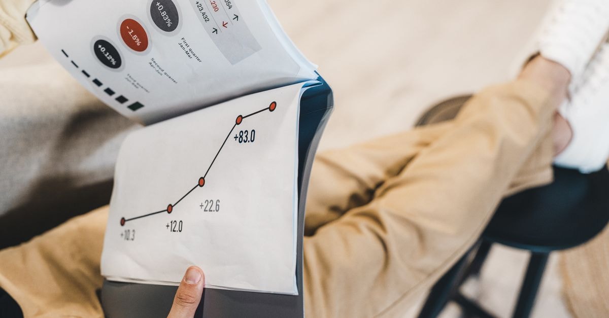 Philip Morris International Reports Q3 2026 Results Close-up of a man reviewing business growth charts and statistics in an office setting.