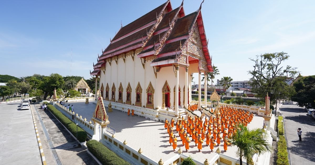 Buritel in Buriram: A City-Center Stay on Han Chana Road Monks in orange robes gather at Wat Klang Phra Aram Luang, Buriram, Thailand for a ceremony.