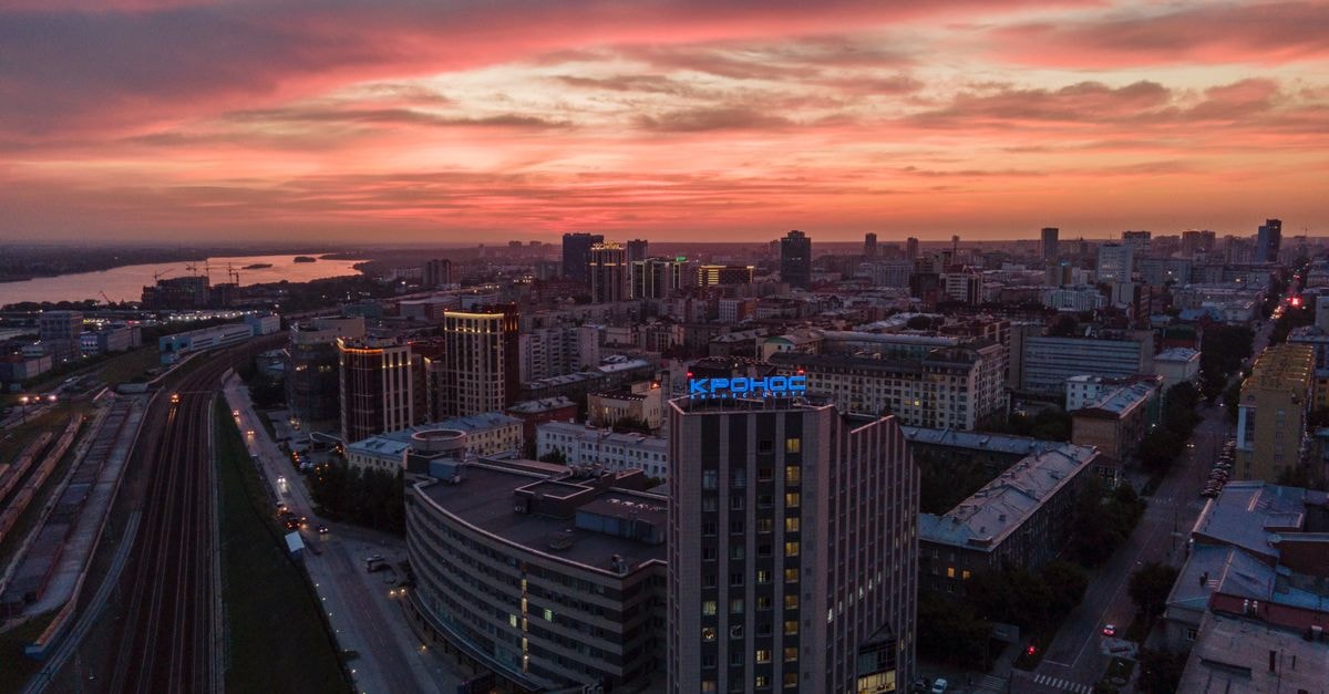 A breathtaking aerial view of Novosibirsk cityscape during sunset, showcasing urban architecture.