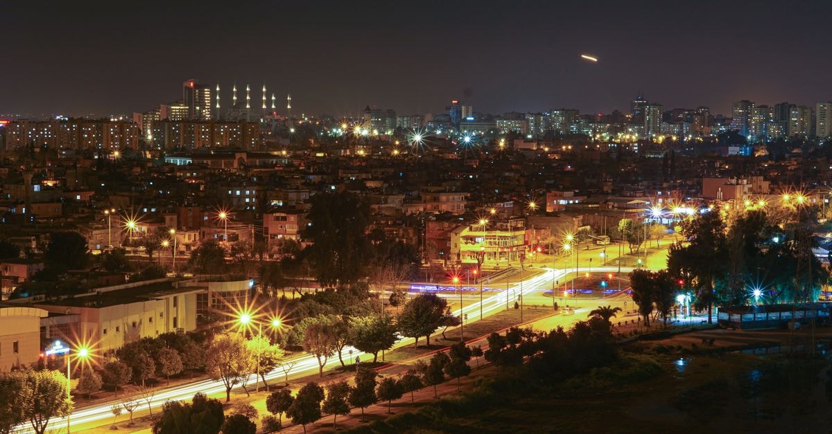 Stunning aerial view of a city at night with bright streetlights and illuminated skyline.