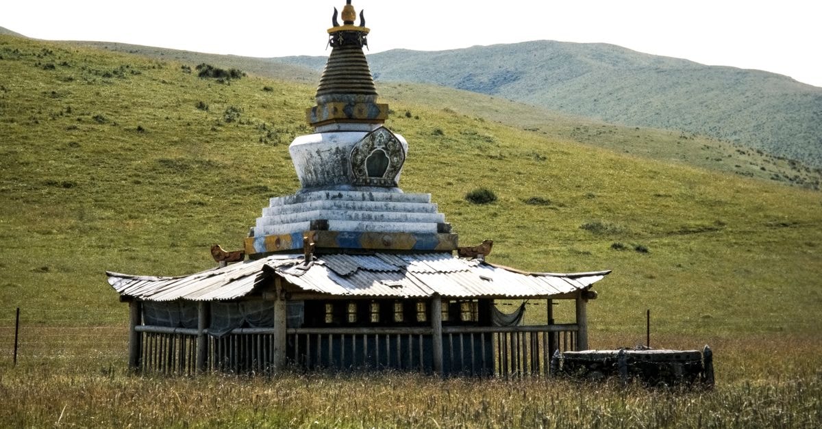 Hulunbuir Travel Guide: Where China's Northern Grasslands Beckon A traditional Buddhist stupa situated in China's serene grasslands, showcasing cultural heritage.