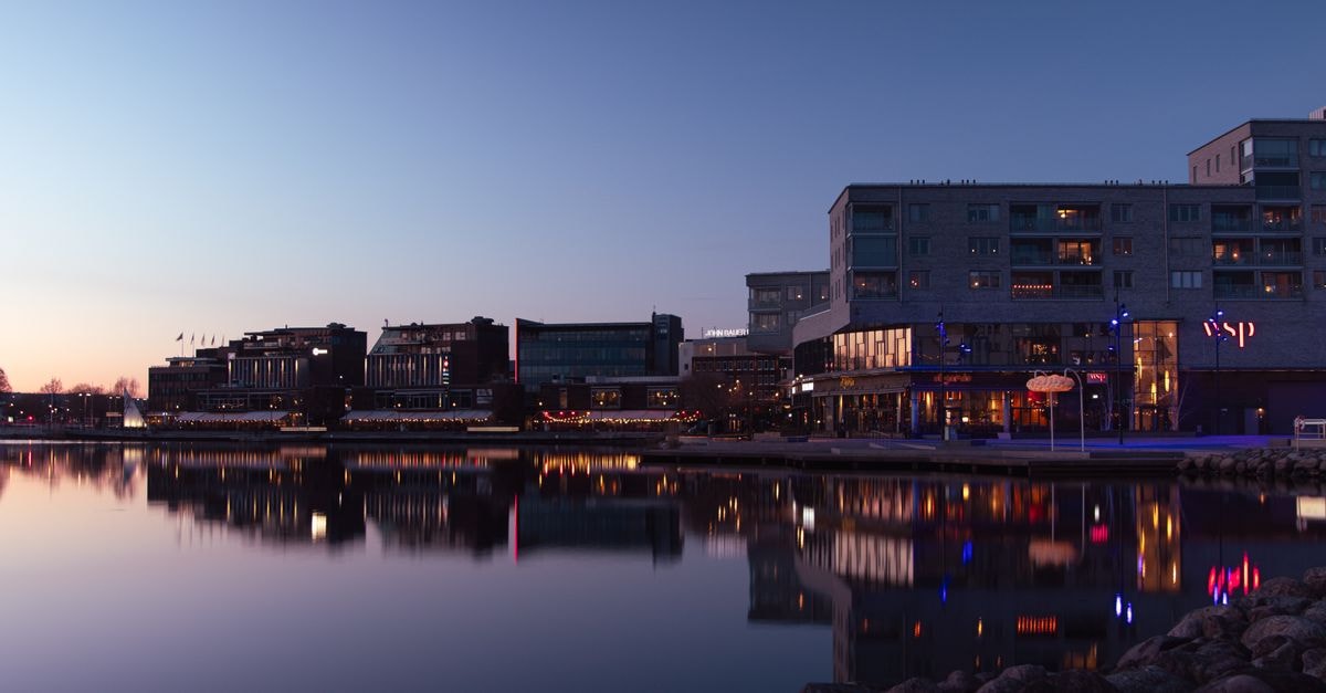 Kuopio Travel Guide: Lakeland Living and Slow Culture Twilight view of Jönköping's illuminated waterfront reflecting on the calm lake surface.