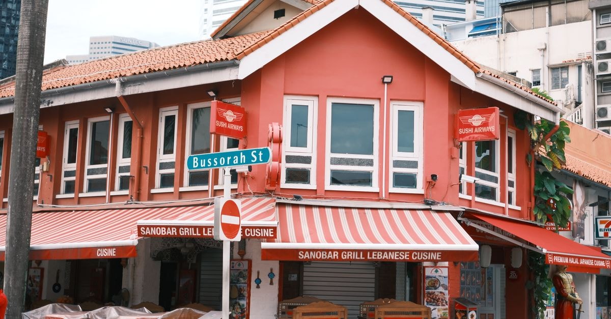 Charming restaurant facade on Bussorah Street, vibrant Singapore cityscape.