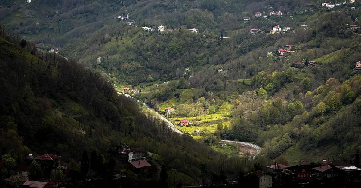 Picturesque mountain landscape with scattered houses and lush greenery capturing the beauty of spring.