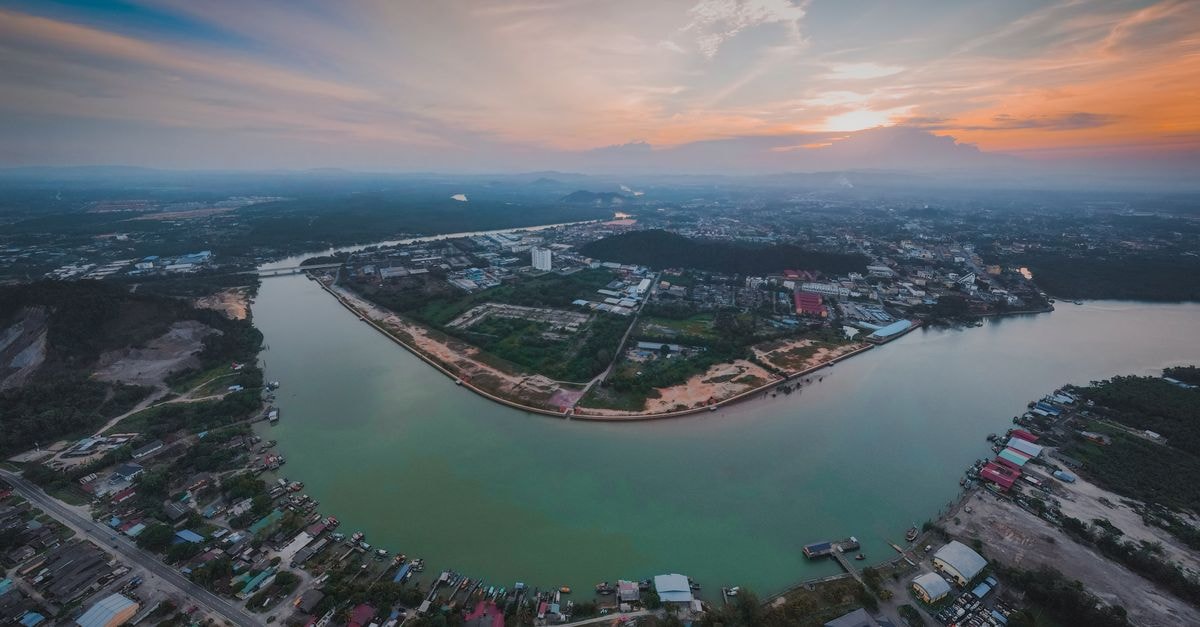 Abby By The River, Ipoh — Riverside Stays Near the Mural Trail Breathtaking aerial view of Chukai cityscape, Terengganu, Malaysia at sunset along the river.