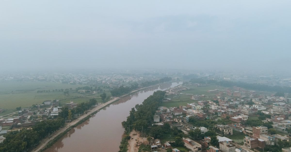 Ramada Encore by Wyndham in Bareilly: A Civil Lines Stay Next to Company Garden Park Aerial shot of a misty morning over Gujranwala, Pakistan, showcasing the city's waterways and residential areas.