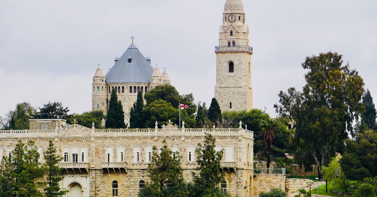 A Quiet Corner of Israel: An Evergreen Haifa Travel Guide View of Jerusalem's Mount Zion with historic architecture and lush greenery.