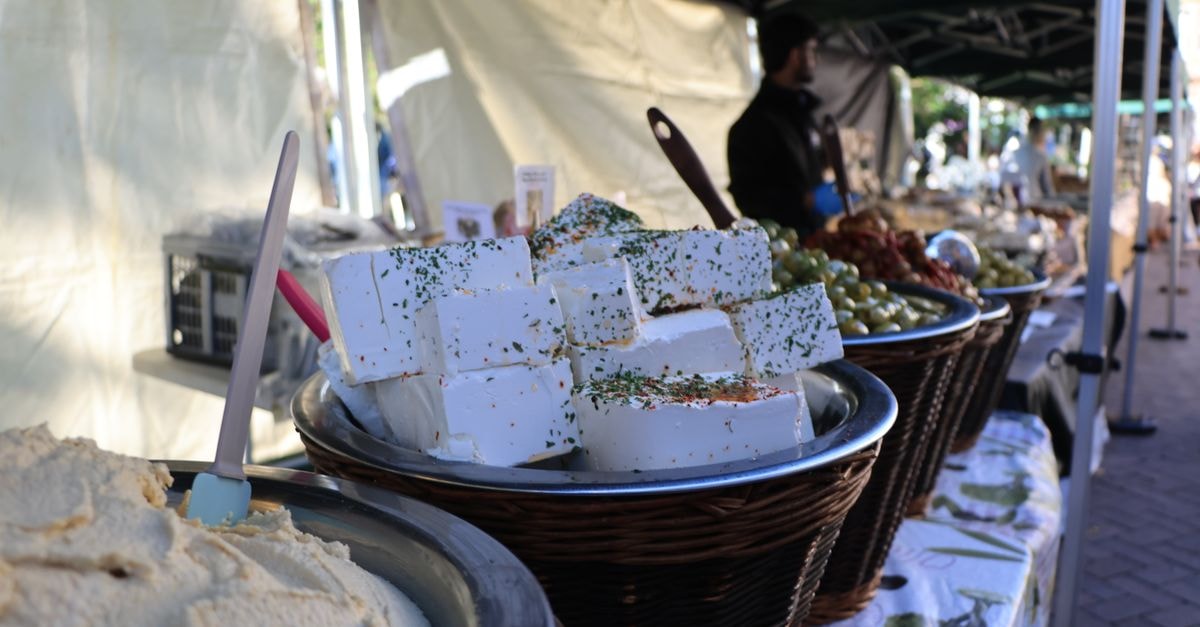 A Slow-Travel Guide to Orléans: Trams, Markets, and Cheese Fresh cheese and produce on display at Nantwich outdoor market, England.