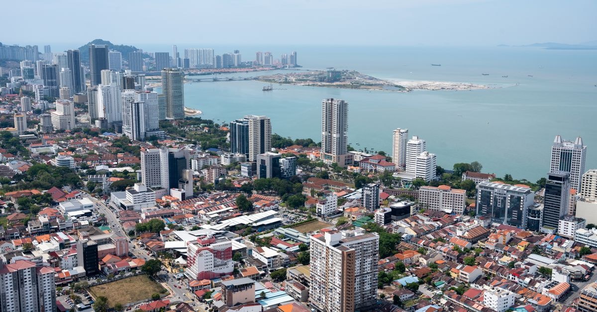 Shahzan Inn, Kuantan: A Heart-of-City Retreat with 127 Rooms A vibrant aerial view of Penang's urban skyline with a coastal backdrop, showcasing modern architecture.