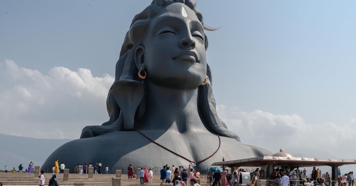 The Adiyogi statue, a spiritual landmark in Coimbatore, Tamil Nadu, attracts numerous visitors under a clear sky.
