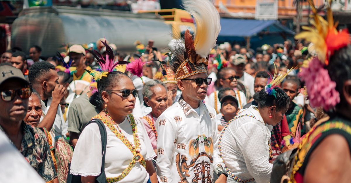 Visiting Lae: a Papua New Guinea city travel guide Colorful festival parade featuring participants in traditional attire and headpieces.