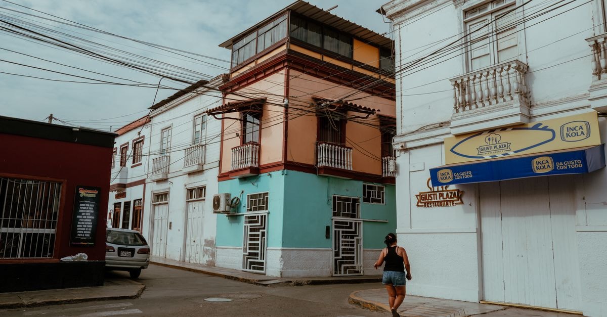 Explore the colorful streets of Pacasmayo, Peru, featuring vibrant buildings and local life.