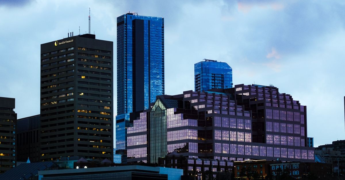 A stunning view of modern skyscrapers at twilight with reflective glass surfaces.