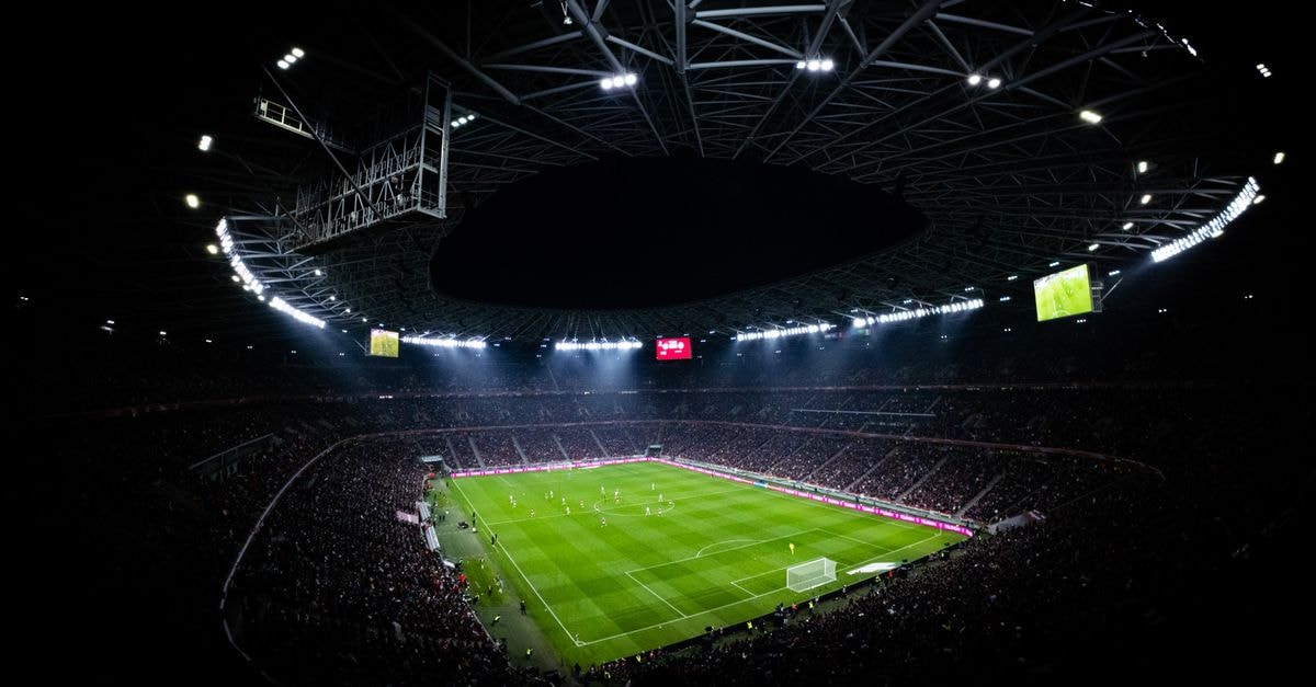 Cleveland Guardians become third AL franchise to reach 10,000 wins, beating Padres 6-1 Aerial view of a night football match in Budapest. Illuminated stadium full of fans adds dramatic atmosphere.