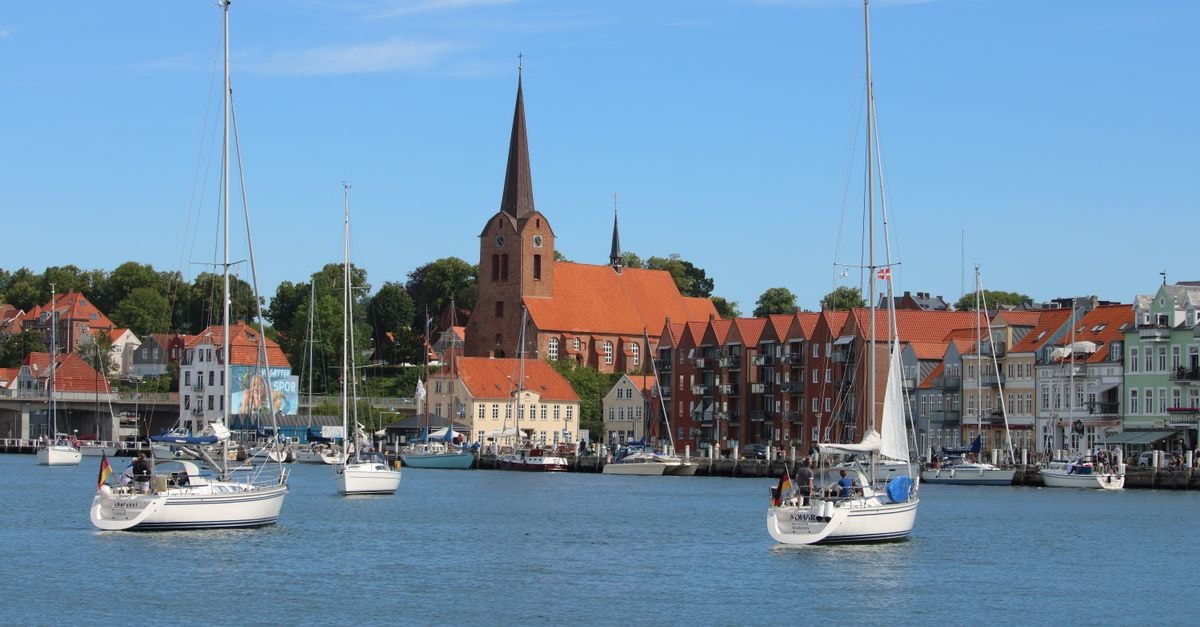 Me and All Hotel Kiel in Kiel: Harbour-View Design Near the Fjord Discover Sønderborg's picturesque harbor with sailboats and historic architecture on a sunny day.