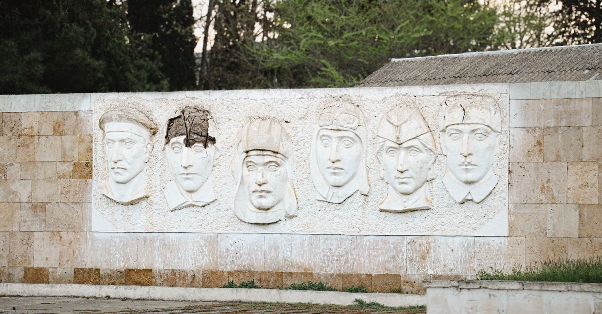 Tiraspol Travel Guide: Soviet Echoes Along the Dniester Outdoor wall-mounted relief sculpture featuring historical figures in Salyan, Azerbaijan.