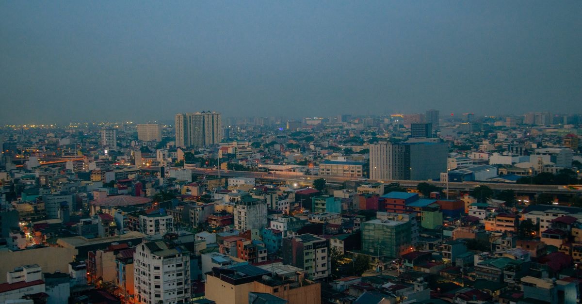 Hotel 99 in Caloocan: A Convenient Stay Near Monumento Landmarks Stunning aerial cityscape showing urban diversity and architecture at twilight.