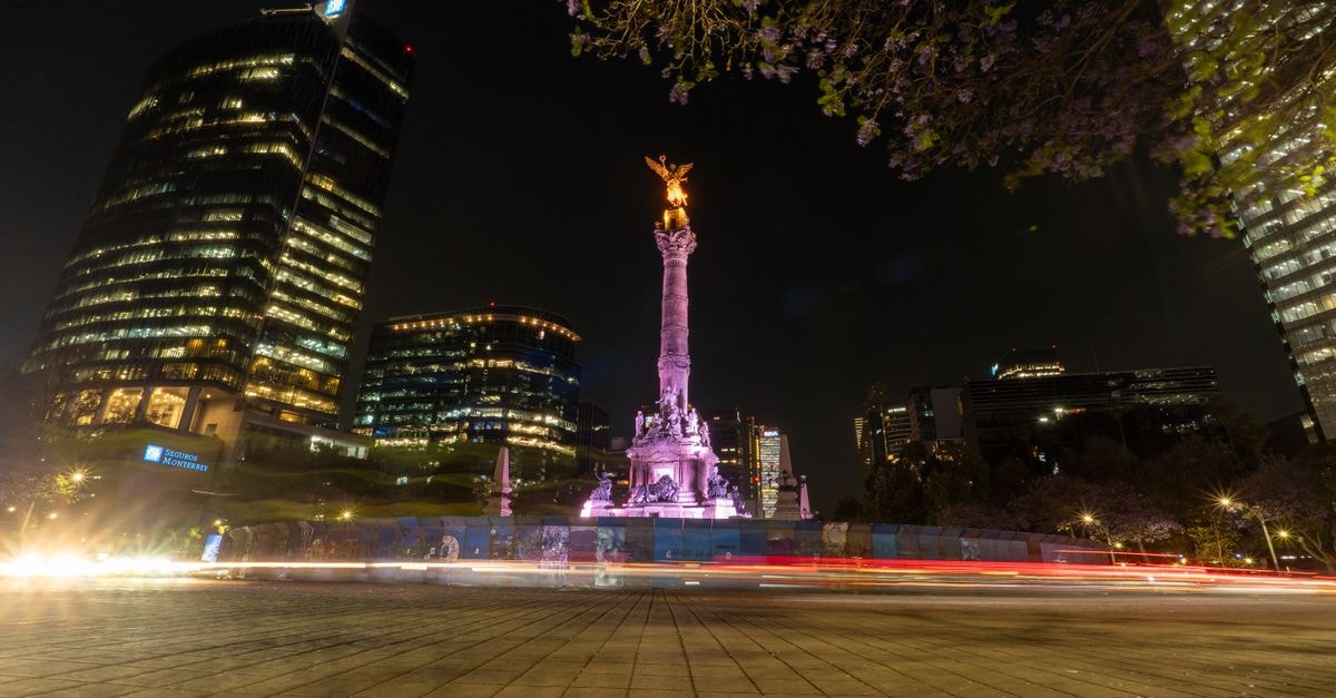 Mexico City Travel Guide: A Slow, Curious Welcome Stunning night view of Angel of Independence on Reforma Avenue in Mexico City, showcasing vibrant city lights.