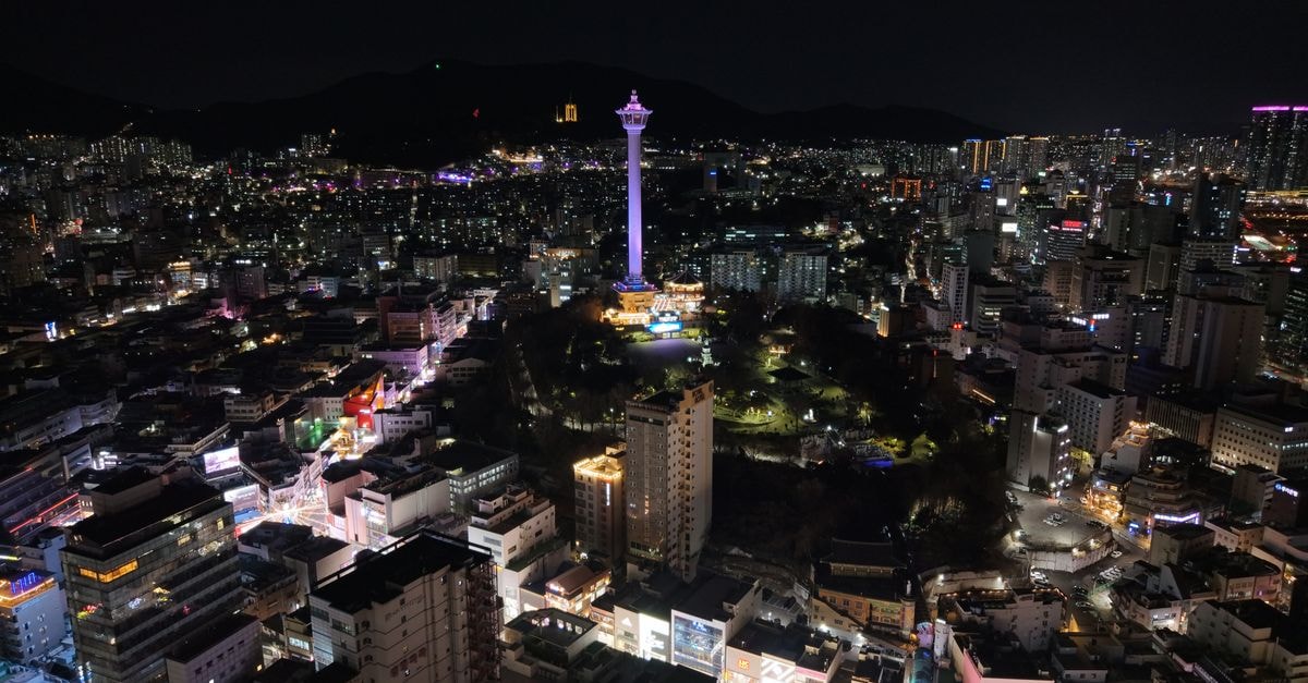 Hotel Foret Premier Nampo in Busan: Suite-Style Stay in the Nampo Neighborhood Stunning aerial shot of Busan Tower surrounded by illuminated cityscape at night in Busan, South Korea.