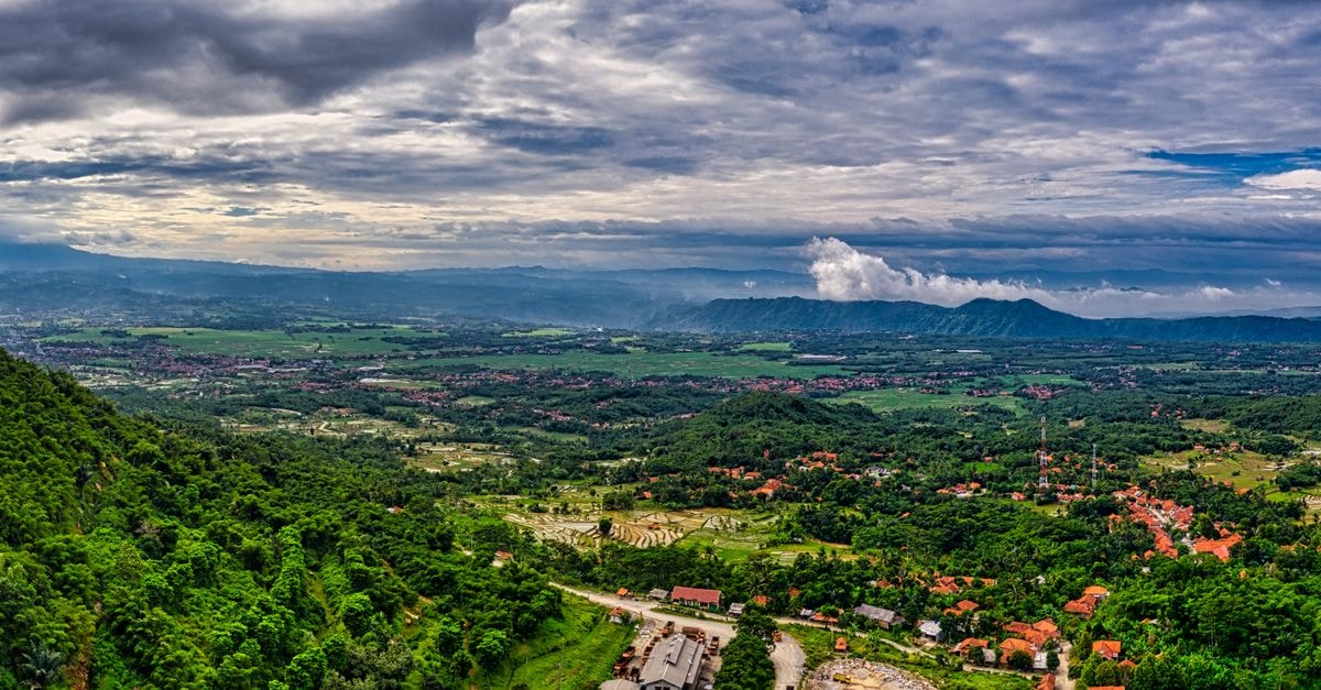 D'Ben Hotel Purwokerto in Purwokerto: A Practical Central Java Base Stunning aerial view of Purwakarta, West Java, showcasing vibrant greenery and mountainous terrain.