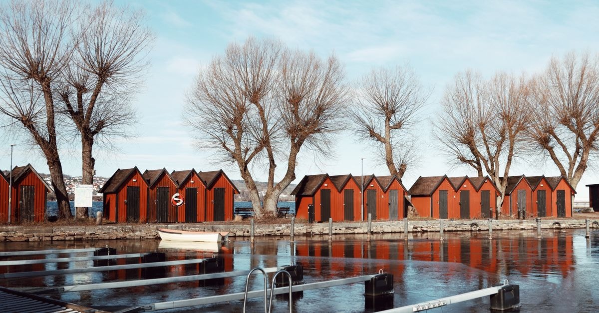Gävle travel guide: a calm, food-led way to discover Sweden's east coast Red boathouses reflecting on a calm lake in Jönköping, Sweden.