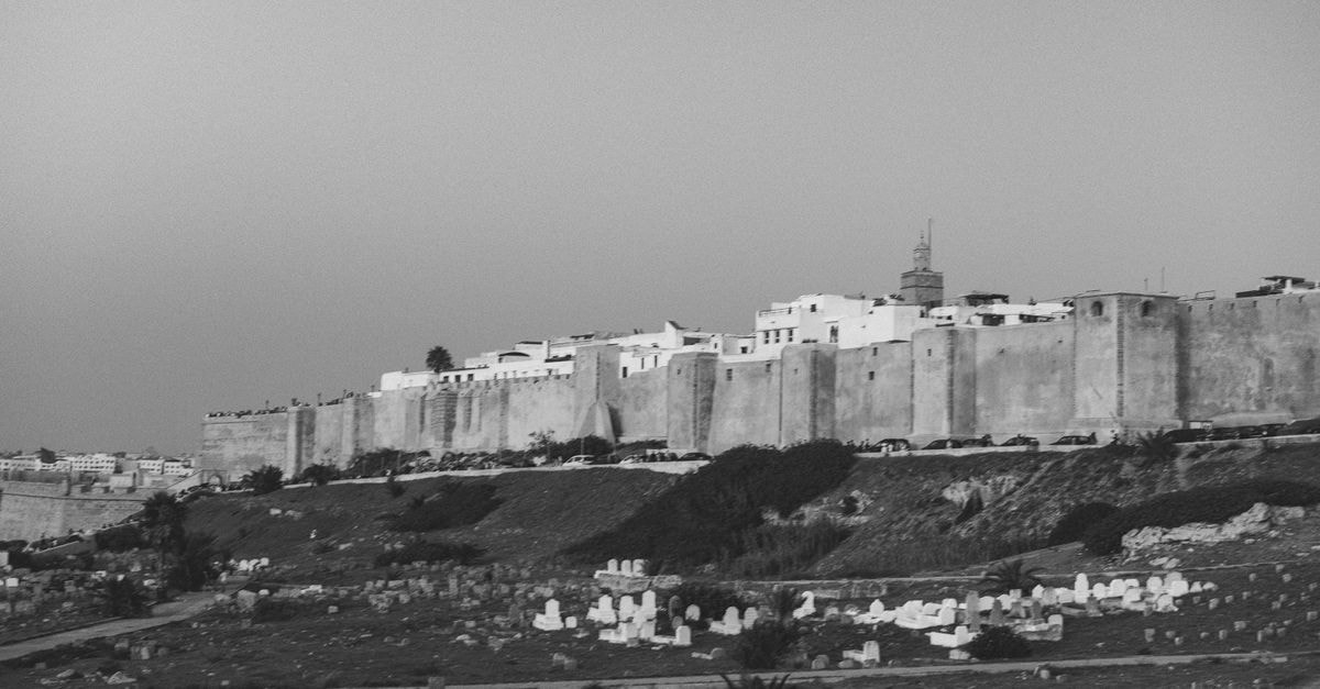 Le Royal Plaza in Kenitra: A Modern Event Address Near Forest Maâmora Black and white view of Rabat's ancient walls and cemetery. A historical glimpse of Morocco.