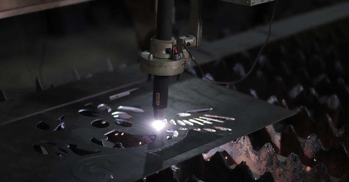 Parker-Hannifin: Industrial Quality, Aerospace Weight, and a Price That Already Does the Work Close-up of a plasma cutting machine working on a metal sheet in an industrial setting.