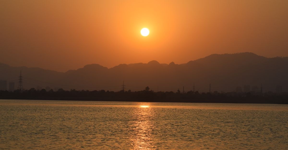 The 108 Hotel, Islamabad: Boutique Stays in the Blue Area Golden sunset over Rawal Lake with Margalla Hills in Islamabad, Pakistan.