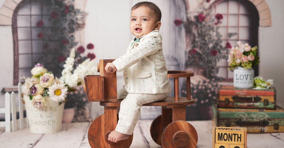 Lithium Carbonate Prices Slide to Five-Month Low as New Projects Reach Milestones Adorable baby in stylish suit sitting on a wooden tricycle with floral background.