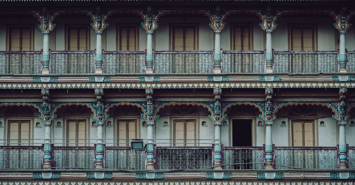 A Thoughtful Vadodara Travel Guide for Slow Explorers A vibrant multi-story historic facade showcasing traditional architecture in Ahmedabad, India.