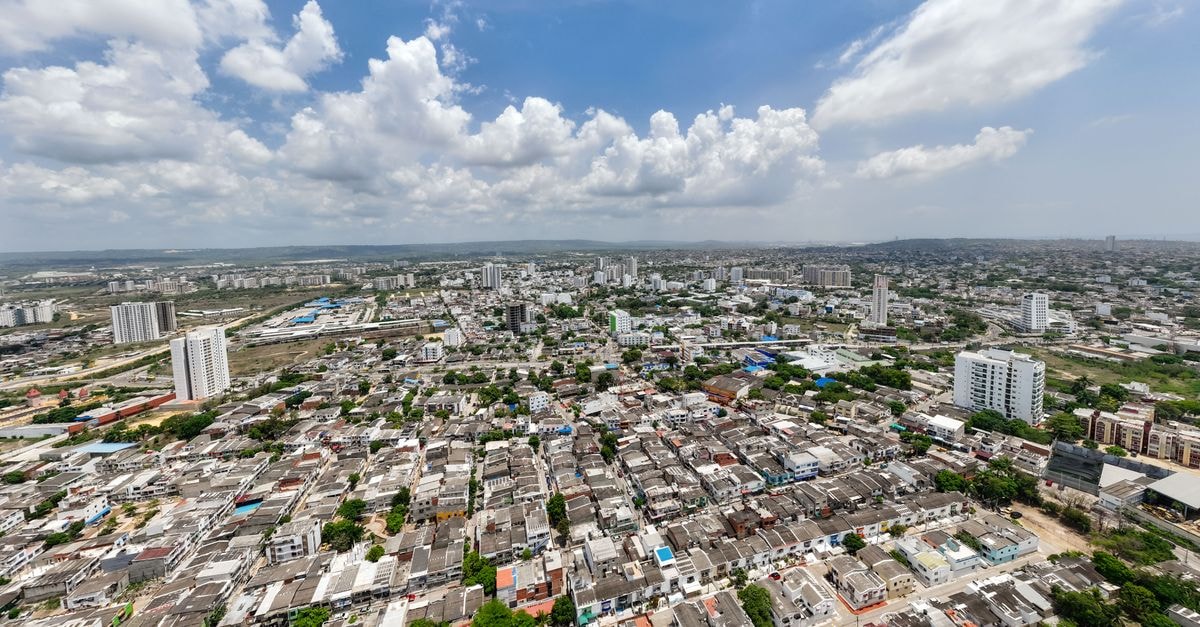 Stunning aerial photograph showcasing an expansive urban cityscape under a bright blue sky.