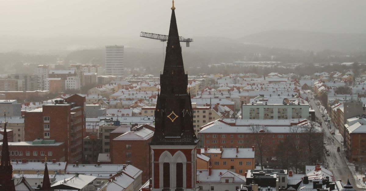 Lymond House, Ootacamund: A Heritage Address on Sylk's Road Aerial view of a snowy city with a prominent church spire during winter.