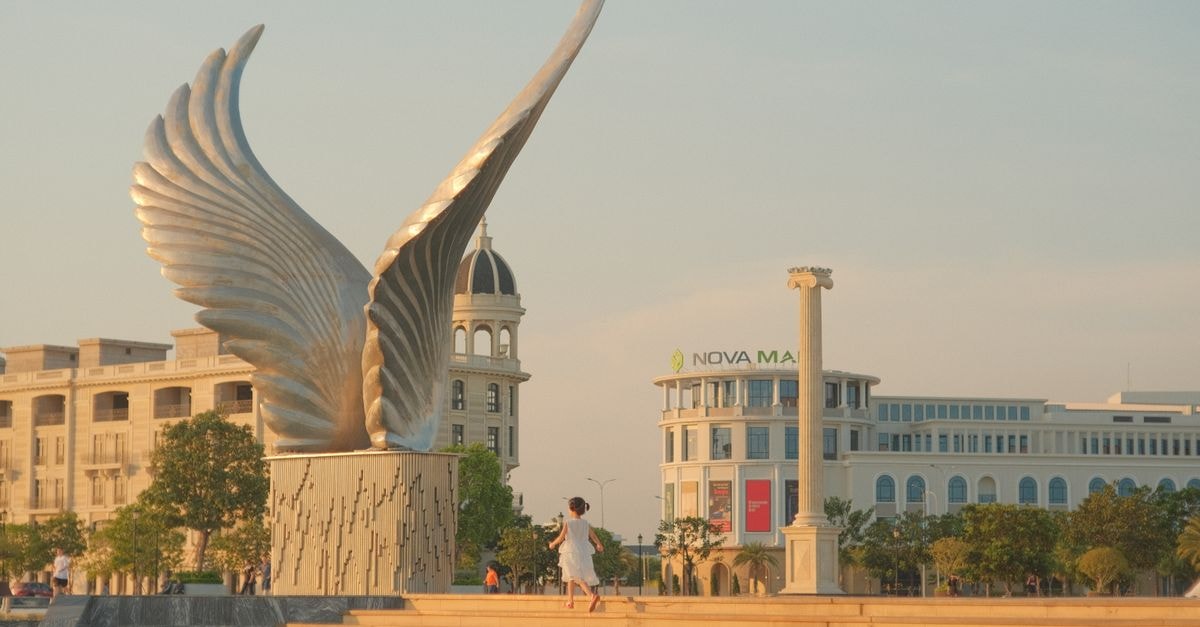 Angeles City Travel Guide: A Gateway Worth Slowing Down For Elegant winged sculpture in a modern plaza with a calm atmosphere.