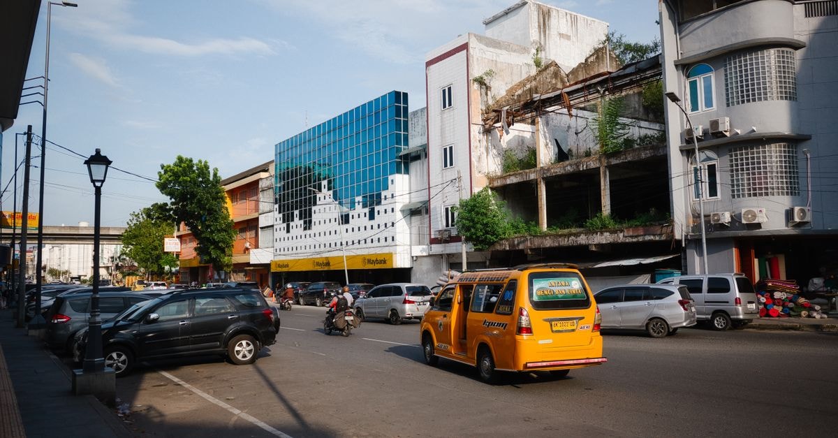 Citi International Palang Merah, Medan — A Compact City Stay on Jalan Listrik Street scene in Medan, North Sumatra showing local traffic and urban architecture during the day.