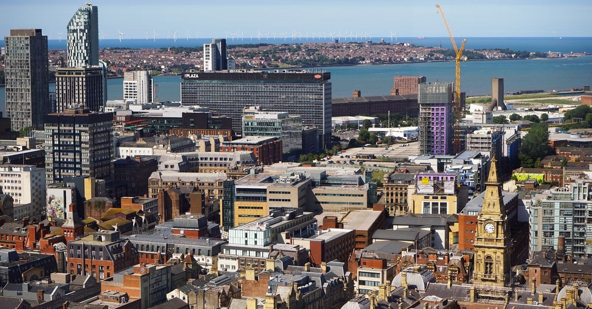 Somersby Guest House in Liverpool: A Quiet Green Lane Stay in Mossley Hill Aerial view of Liverpool showcasing modern skyscrapers and historic architecture by the harbor.