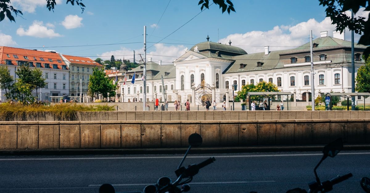 View of the Presidential Palace in Bratislava with pedestrians in the foreground.